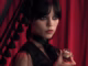 Jenna ortega holds a locket as the titular character in wednesday
