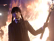 Jenna ortega s wednesday looking angry and holding a torch in front of a fire in wednesday season